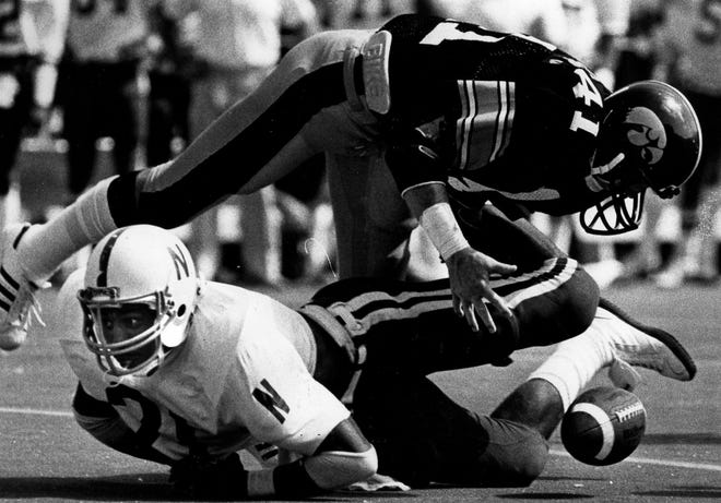 Iowa’s Bobby Stoops, top, recovers a fumble by Nebraska’s Roger Craig in 1981. “Boy, he was tough,” Stoops said of Craig.