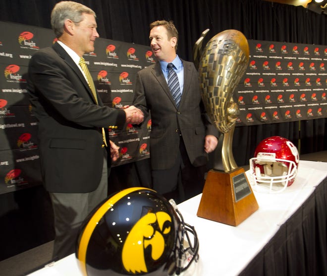 Iowa coach Kirk Ferentz, left, greets Oklahoma's Bob Stoops at an Insight Bowl news conference on Dec. 29, 2011.