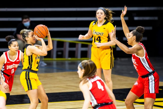 Iowa guard Gabbie Marshall (24) makes a basket as Ohio State forward Aaliyah Patty, right, defends during a NCAA Big Ten Conference women's basketball game, Wednesday, Jan. 13, 2021, at Carver-Hawkeye Arena in Iowa City, Iowa.