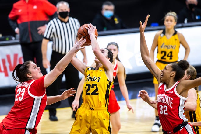 Iowa guard Caitlin Clark (22) gets fouled by Ohio State forward Rebeka Mikulášiková, left, as Ohio State forward Aaliyah Patty (32) defends during a NCAA Big Ten Conference women's basketball game, Wednesday, Jan. 13, 2021, at Carver-Hawkeye Arena in Iowa City, Iowa.