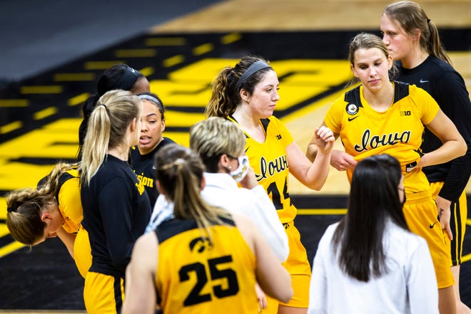 Iowa Hawkeyes players react after losing to the Ohio State Buckeyes in overtime during a NCAA Big Ten Conference women's basketball game, Wednesday, Jan. 13, 2021, at Carver-Hawkeye Arena in Iowa City, Iowa.