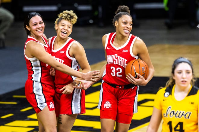 Ohio State guard Braxtin Miller, left, and Rikki Harris celebrate with teammate Aaliyah Patty (32) after defeating the Iowa Hawkeyes in overtime during a NCAA Big Ten Conference women's basketball game, Wednesday, Jan. 13, 2021, at Carver-Hawkeye Arena in Iowa City, Iowa.