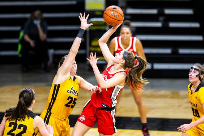 Ohio State guard Jacy Sheldon (4) makes a basket as Iowa center Monika Czinano (25) defends during a NCAA Big Ten Conference women's basketball game, Wednesday, Jan. 13, 2021, at Carver-Hawkeye Arena in Iowa City, Iowa.