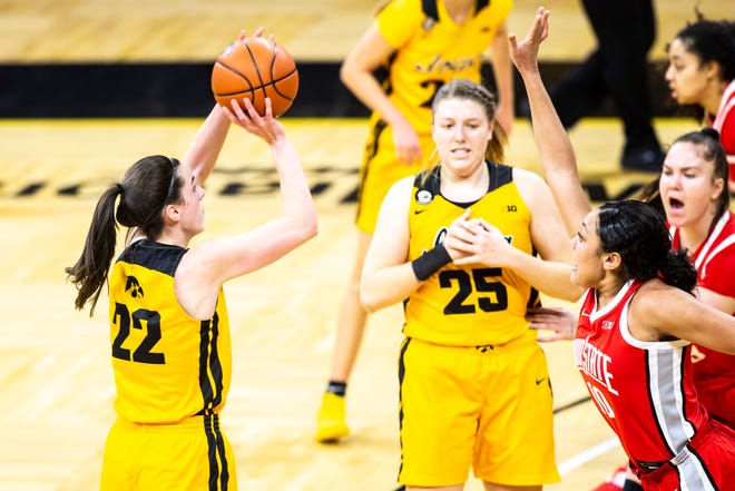 Iowa guard Caitlin Clark (22) makes a 3-point basket as Ohio State guard Braxtin Miller (10) defends during a NCAA Big Ten Conference women's basketball game, Wednesday, Jan. 13, 2021, at Carver-Hawkeye Arena in Iowa City, Iowa.