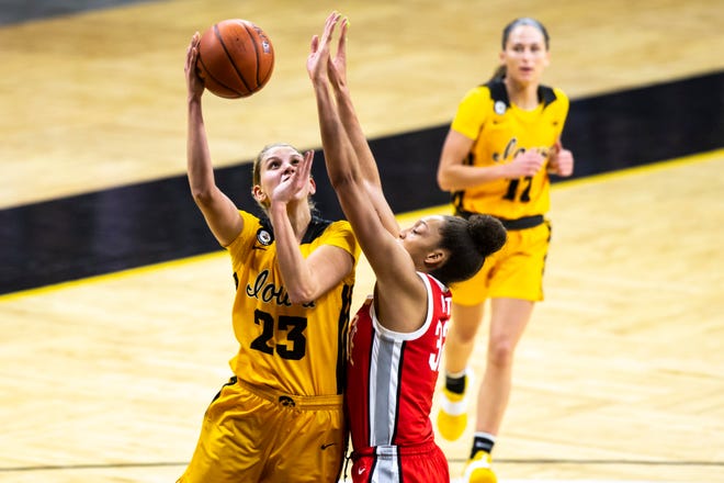 Iowa forward Logan Cook (23) makes a basket as Ohio State forward Aaliyah Patty, right, defends during a NCAA Big Ten Conference women's basketball game, Wednesday, Jan. 13, 2021, at Carver-Hawkeye Arena in Iowa City, Iowa.