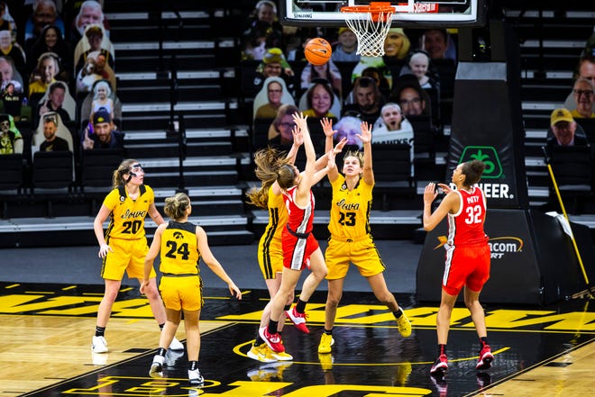 Ohio State guard Jacy Sheldon (4) gets fouled by Iowa's McKenna Warnock, left, as Iowa forward Logan Cook (23) defends during a NCAA Big Ten Conference women's basketball game, Wednesday, Jan. 13, 2021, at Carver-Hawkeye Arena in Iowa City, Iowa.