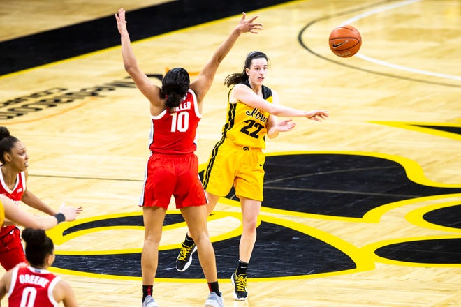Iowa guard Caitlin Clark (22) passes as Ohio State guard Braxtin Miller (10) defends during a NCAA Big Ten Conference women's basketball game, Wednesday, Jan. 13, 2021, at Carver-Hawkeye Arena in Iowa City, Iowa.