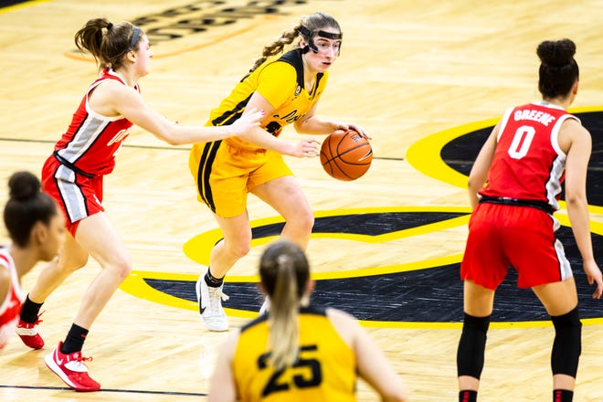 Iowa guard Kate Martin (20) dribbles as Ohio State guard Jacy Sheldon, left, defends during a NCAA Big Ten Conference women's basketball game, Wednesday, Jan. 13, 2021, at Carver-Hawkeye Arena in Iowa City, Iowa.