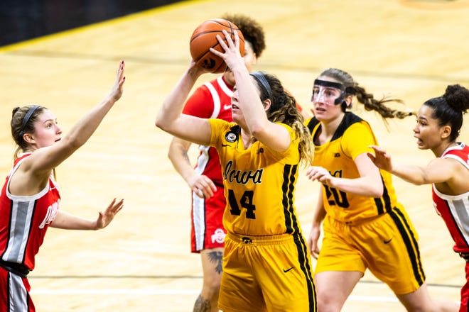 Iowa guard Gabbie Marshall (24) makes a basket as Ohio State guard Jacy Sheldon, left, defends during a NCAA Big Ten Conference women's basketball game, Wednesday, Jan. 13, 2021, at Carver-Hawkeye Arena in Iowa City, Iowa.