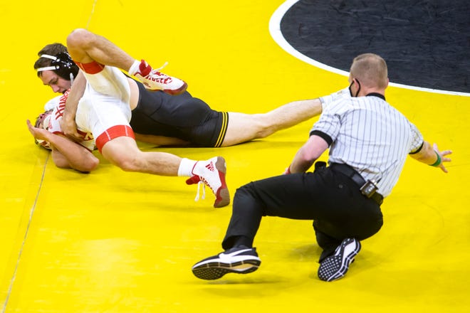 Iowa's Spencer Lee, top, scores a four-point near fall on Nebraska's Liam Cronin at 125 pounds during a NCAA Big Ten Conference wrestling dual, Friday, Jan. 15, 2021, at Carver-Hawkeye Arena in Iowa City, Iowa.