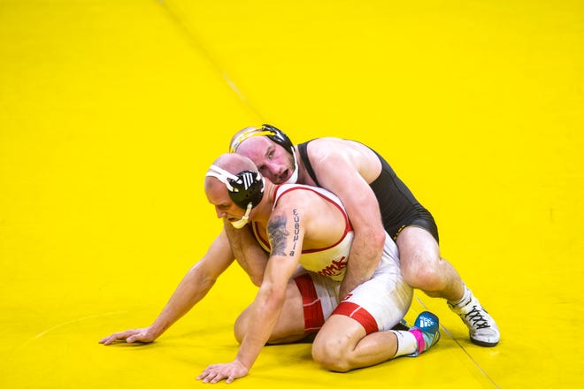 Iowa's Alex Marinelli, top, wrestles Nebraska's Peyton Robb at 165 pounds during a NCAA Big Ten Conference wrestling dual, Friday, Jan. 15, 2021, at Carver-Hawkeye Arena in Iowa City, Iowa.