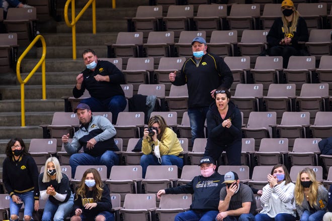 Iowa Hawkeyes fans cheer during a NCAA Big Ten Conference wrestling dual against Nebraska amid the novel coronavirus pandemic, Friday, Jan. 15, 2021, at Carver-Hawkeye Arena in Iowa City, Iowa.