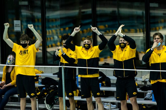 Iowa swimmers cheer on teammates during a NCAA Big Ten Conference swimming and diving meet, Saturday, Jan. 16, 2021, at the Campus Recreation and Wellness Center on the University of Iowa campus in Iowa City, Iowa.