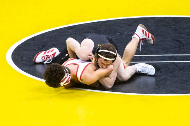 Iowa's Spencer Lee, top, wrestles Nebraska's Liam Cronin at 125 pounds during a NCAA Big Ten Conference wrestling dual, Friday, Jan. 15, 2021, at Carver-Hawkeye Arena in Iowa City, Iowa.