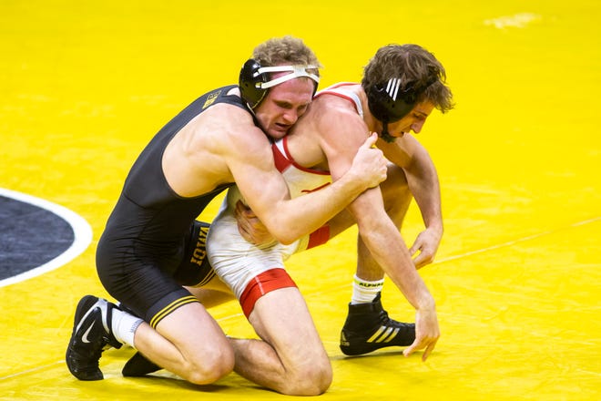 Iowa's Kaleb Young, left, wrestles Nebraska's Kaleb Licking at 157 pounds during a NCAA Big Ten Conference wrestling dual, Friday, Jan. 15, 2021, at Carver-Hawkeye Arena in Iowa City, Iowa.