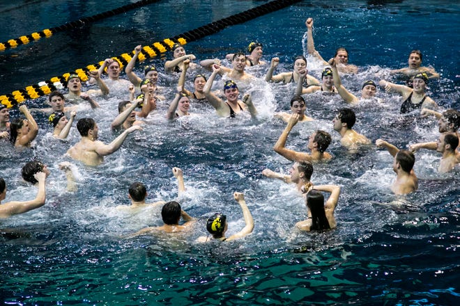 Iowa Hawkeyes celebrate in the diving pool after a NCAA Big Ten Conference swimming and diving meet, Saturday, Jan. 16, 2021, at the Campus Recreation and Wellness Center on the University of Iowa campus in Iowa City, Iowa.