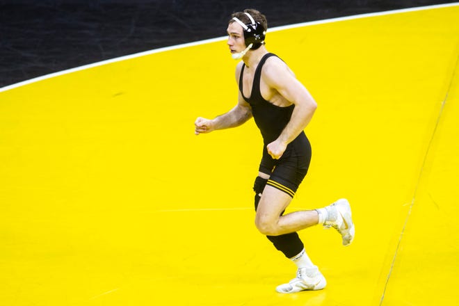 Iowa's Spencer Lee runs off the mat after wrestling at 125 pounds during a NCAA Big Ten Conference wrestling dual against Nebraska, Friday, Jan. 15, 2021, at Carver-Hawkeye Arena in Iowa City, Iowa.