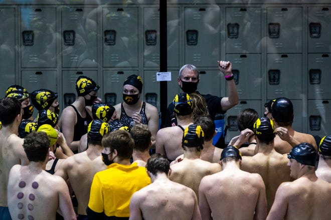 Iowa head coach Marc Long huddles up with athletes during a NCAA Big Ten Conference swimming and diving meet, Saturday, Jan. 16, 2021, at the Campus Recreation and Wellness Center on the University of Iowa campus in Iowa City, Iowa.