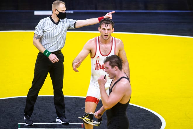 Nebraska's Eric Schultz, middle, reaches out for a handshake from Iowa's Jacob Warner after their match at 197 pounds during a NCAA Big Ten Conference wrestling dual, Friday, Jan. 15, 2021, at Carver-Hawkeye Arena in Iowa City, Iowa.