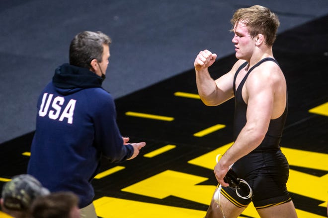 Iowa associate head coach Terry Brands celebrates with Nelson Brands after his match at 174 pounds during a NCAA Big Ten Conference wrestling dual against Nebraska, Friday, Jan. 15, 2021, at Carver-Hawkeye Arena in Iowa City, Iowa.