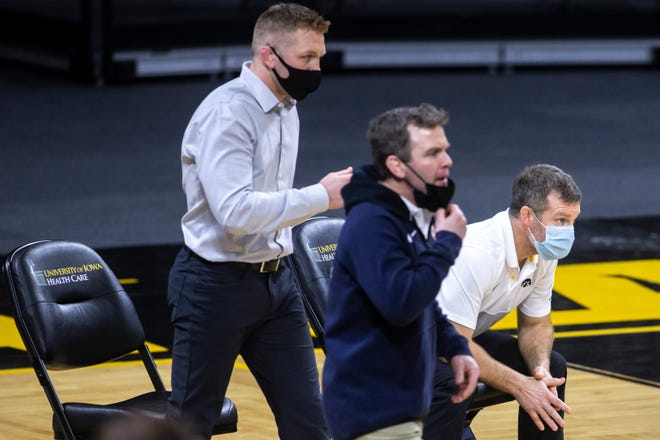 Iowa head coach Tom Brands, right, Iowa assistant coach Ryan Morningstar, left, and Iowa associate head coach Terry Brands, middle, call out instructions during a NCAA Big Ten Conference wrestling dual, Friday, Jan. 15, 2021, at Carver-Hawkeye Arena in Iowa City, Iowa.