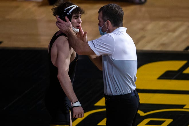 Iowa head coach Tom Brands smacks Austin DeSanto before he wrestles at 133 pounds during a NCAA Big Ten Conference wrestling dual against Nebraska, Friday, Jan. 15, 2021, at Carver-Hawkeye Arena in Iowa City, Iowa.