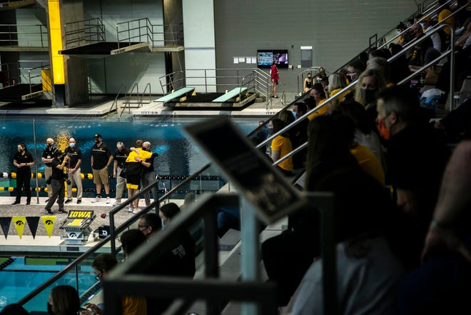Iowa coach Marc Long hugs a senior before a NCAA Big Ten Conference swimming and diving meet, Saturday, Jan. 16, 2021, at the Campus Recreation and Wellness Center on the University of Iowa campus in Iowa City, Iowa.