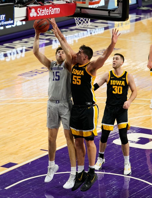 Jan 17, 2021; Evanston, Illinois, USA; Northwestern Wildcats center Ryan Young (15) shoots the ball against Iowa Hawkeyes center Luka Garza (55) during the second half at Welsh-Ryan Arena.
