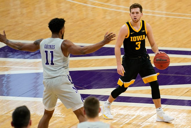 Jan 17, 2021; Evanston, Illinois, USA; Iowa Hawkeyes guard Jordan Bohannon (3) dribbles the ball against Northwestern Wildcats guard Anthony Gaines (11) during the first half at Welsh-Ryan Arena.