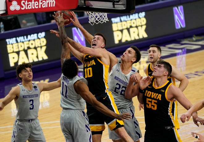Jan 17, 2021; Evanston, Illinois, USA; Iowa Hawkeyes guard Joe Wieskamp (10) shoots the ball against Northwestern Wildcats guard Anthony Gaines (11) during the first half at Welsh-Ryan Arena.
