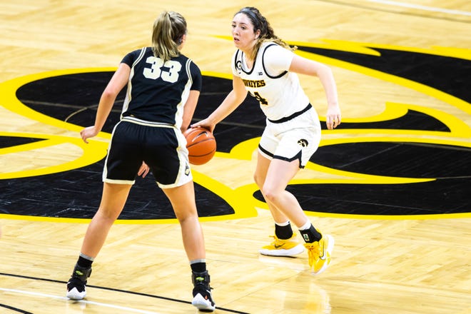 Iowa's McKenna Warnock (14) takes the ball up court as Purdue guard Madison Layden (33) defends during a NCAA Big Ten Conference women's basketball game, Monday, Jan. 18, 2021, at Carver-Hawkeye Arena in Iowa City, Iowa.