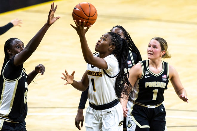 Iowa guard Tomi Taiwo (1) makes a basket as Purdue center Fatou Diagne, left, defends during a NCAA Big Ten Conference women's basketball game, Monday, Jan. 18, 2021, at Carver-Hawkeye Arena in Iowa City, Iowa.