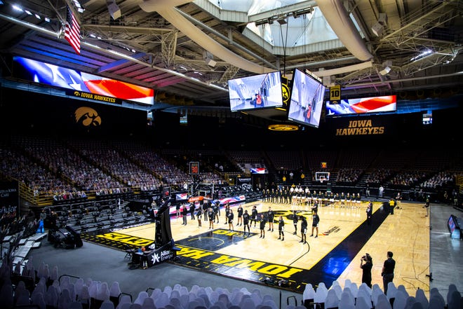 Purdue Boilermakers and Iowa Hawkeyes players stand as the national anthem is played during a NCAA Big Ten Conference women's basketball game, Monday, Jan. 18, 2021, at Carver-Hawkeye Arena in Iowa City, Iowa.