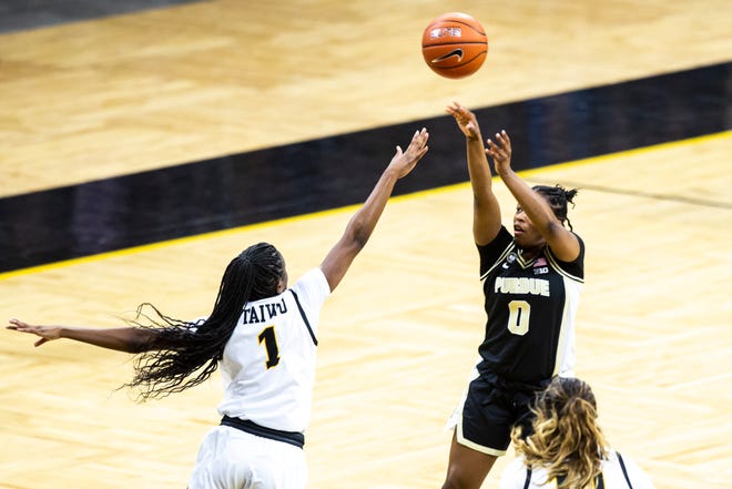 Purdue guard Brooke Moore (0) makes a 3-point basket as Iowa guard Tomi Taiwo (1) defends during a NCAA Big Ten Conference women's basketball game, Monday, Jan. 18, 2021, at Carver-Hawkeye Arena in Iowa City, Iowa.
