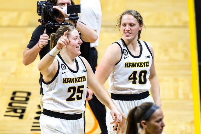 Iowa center Monika Czinano (25) holds up one finger while celebrating with teammate Sharon Goodman (40) after the Hawkeyes defeated Purdue during a NCAA Big Ten Conference women's basketball game, Monday, Jan. 18, 2021, at Carver-Hawkeye Arena in Iowa City, Iowa.