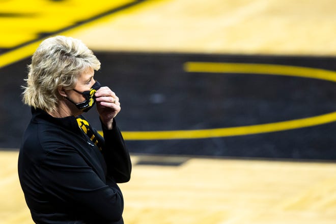 Iowa head coach Lisa Bluder stands on the baseline while wearing a face mask during a NCAA Big Ten Conference women's basketball game against Purdue, Monday, Jan. 18, 2021, at Carver-Hawkeye Arena in Iowa City, Iowa.
