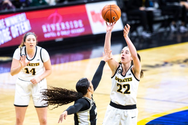 Iowa guard Caitlin Clark (22) makes a basket as Purdue guard Kayana Traylor defends during a NCAA Big Ten Conference women's basketball game, Monday, Jan. 18, 2021, at Carver-Hawkeye Arena in Iowa City, Iowa.