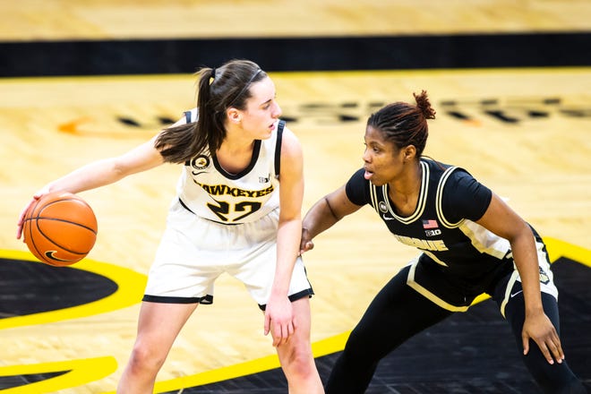 Iowa guard Caitlin Clark (22) looks to pass as Purdue guard Rokia Doumbia, right, defends during a NCAA Big Ten Conference women's basketball game, Monday, Jan. 18, 2021, at Carver-Hawkeye Arena in Iowa City, Iowa.
