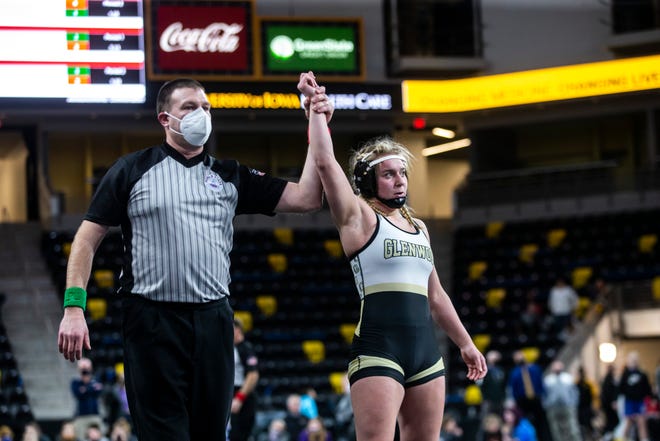 Glenwood's Abby McIntyre has her hand raised after winning her match at 138 pounds during the finals of the Iowa Wrestling Coaches and Officials Association (IWCOA) girls' state wrestling tournament, Saturday, Jan. 23, 2021, at the Xtream Arena in Coralville, Iowa.