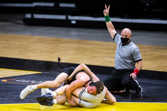 Iowa's Max Murin, top, scores a takedown on Illinois Michael Carr at 149 pounds during a NCAA Big Ten Conference wrestling dual, Sunday, Jan. 31, 2021, at Carver-Hawkeye Arena in Iowa City, Iowa.
