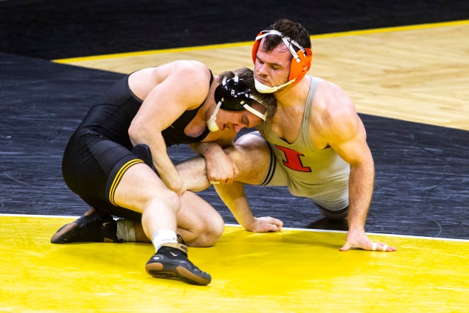 Iowa's Nelson Brands, left, wrestles Illinois' Zach Braunagel at 184 pounds during a NCAA Big Ten Conference wrestling dual, Sunday, Jan. 31, 2021, at Carver-Hawkeye Arena in Iowa City, Iowa.