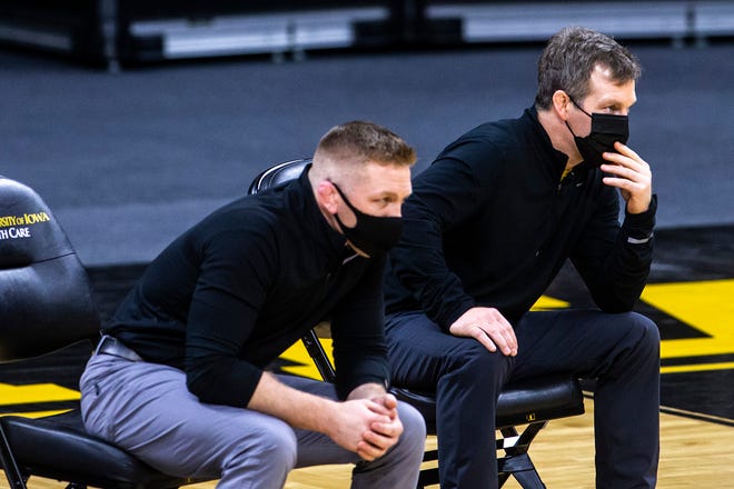 Iowa head coach Tom Brands, right, and Iowa assistant coach Ryan Morningstar give instructions from the bench during a NCAA Big Ten Conference wrestling dual against the Illinois Fighting Illini, Sunday, Jan. 31, 2021, at Carver-Hawkeye Arena in Iowa City, Iowa.