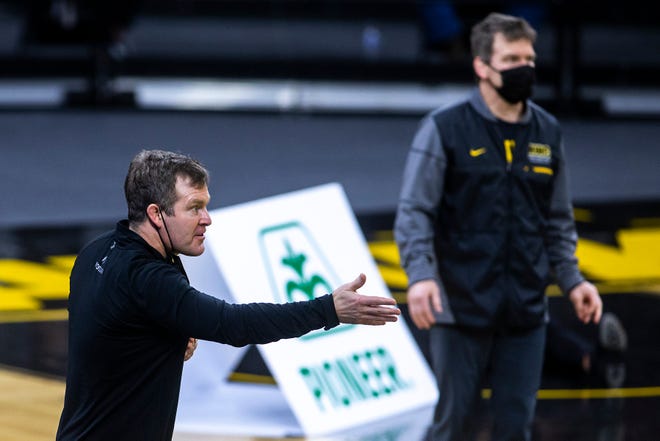 Iowa head coach Tom Brands, left, and Iowa associate head coach Terry Brands react during a NCAA Big Ten Conference wrestling dual against the Illinois Fighting Illini, Sunday, Jan. 31, 2021, at Carver-Hawkeye Arena in Iowa City, Iowa.