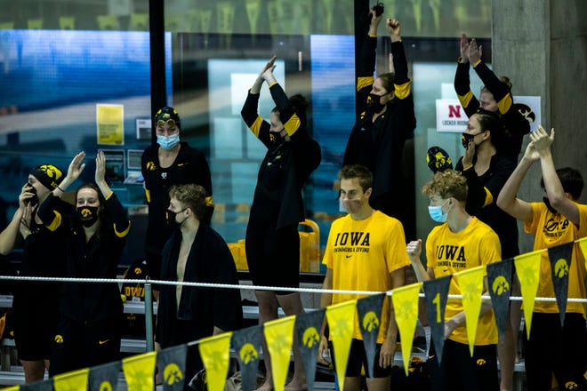 Iowa Hawkeyes swimmers cheer on teammates during a NCAA Big Ten Conference swimming and diving meet, Saturday, Jan. 16, 2021, at the Campus Recreation and Wellness Center on the University of Iowa campus in Iowa City, Iowa. The meet would have been the last for the swimmers, but on Feb. 15 , the University announced it is backing off its decision to cut women ' s swimming.