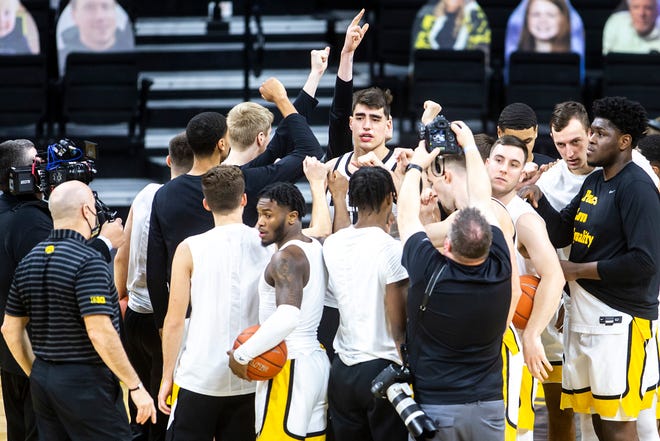 Iowa center Luka Garza, middle, huddles up with teammates before a NCAA Big Ten Conference men's basketball game against Penn State, Sunday, Feb. 21, 2021, at Carver-Hawkeye Arena in Iowa City, Iowa.