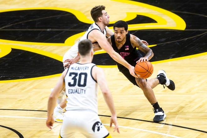 Iowa guard Jordan Bohannon, left, defends as Penn State guard Sam Sessoms drives during a NCAA Big Ten Conference men's basketball game, Sunday, Feb. 21, 2021, at Carver-Hawkeye Arena in Iowa City, Iowa.