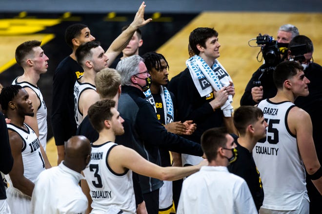 Iowa head coach Fran McCaffery and players wave to fans after a NCAA Big Ten Conference men's basketball game against Penn State, Sunday, Feb. 21, 2021, at Carver-Hawkeye Arena in Iowa City, Iowa.