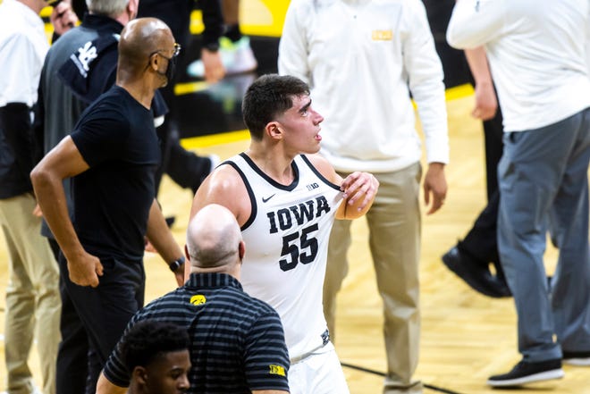 Iowa center Luka Garza (55) looks up at the scoreboard while walking into the locker room at halftime during a NCAA Big Ten Conference men's basketball game against Penn State, Sunday, Feb. 21, 2021, at Carver-Hawkeye Arena in Iowa City, Iowa.