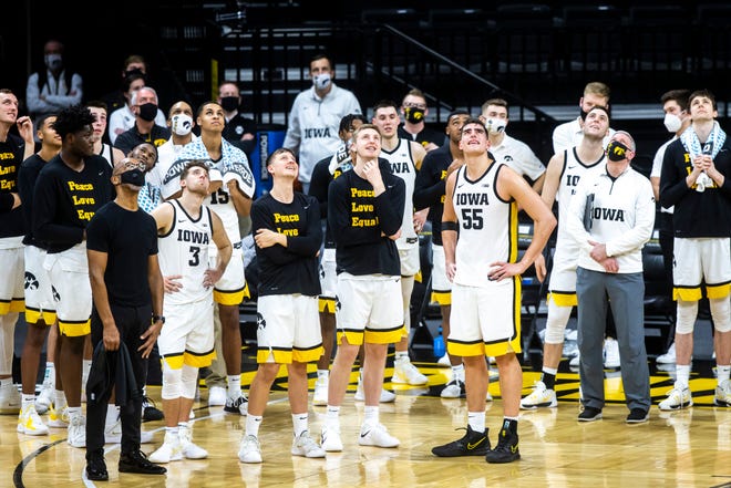 Iowa Hawkeyes players watch a video presentation with teammate Iowa center Luka Garza (55) after a NCAA Big Ten Conference men's basketball game against Penn State, Sunday, Feb. 21, 2021, at Carver-Hawkeye Arena in Iowa City, Iowa.