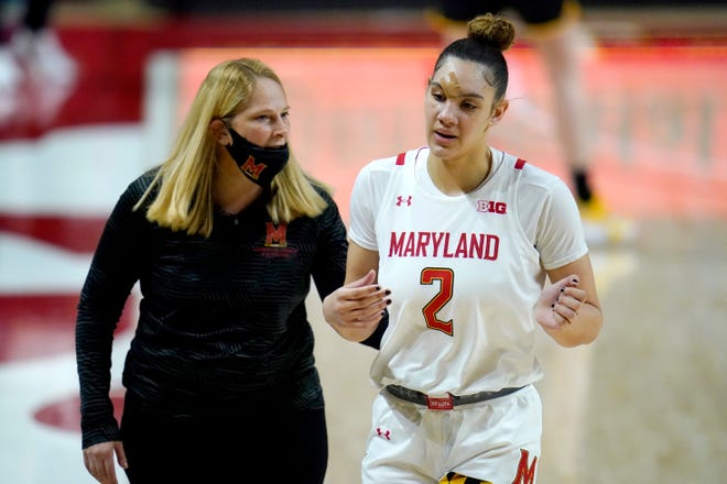 Maryland forward Mimi Collins (2) walks to the bench with head coach Brenda Frese during the first half of an NCAA college basketball game against the Iowa, Tuesday, Feb. 23, 2021, in College Park, Md.